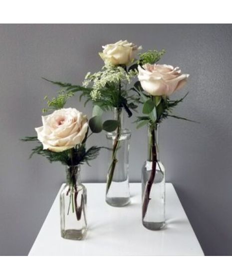 garden-style blush roses in bud vases for events