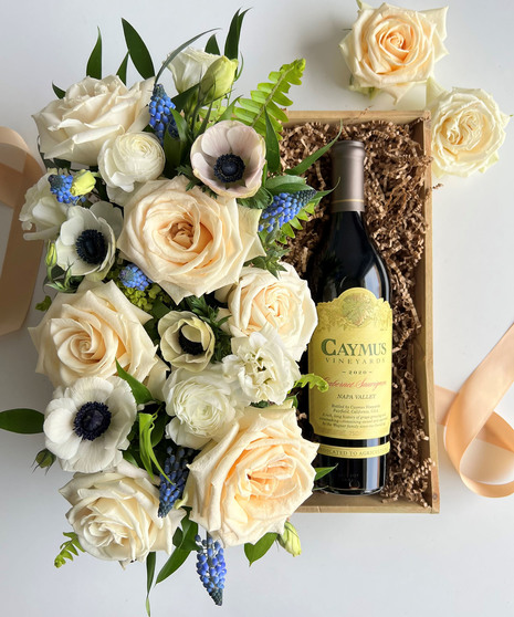 cream colored floral arrangement with wine