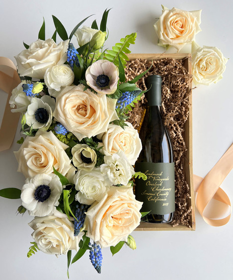 cream colored floral arrangement with wine