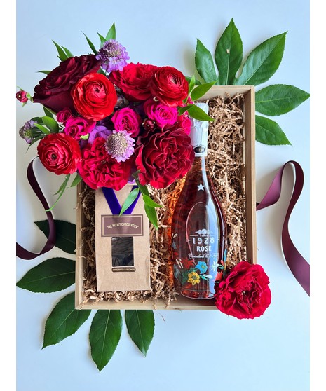 gift basket with floral arrangement, rose, and chocolate