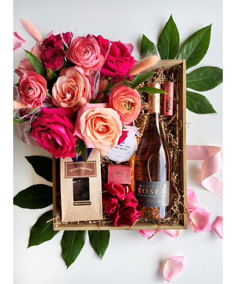 barbie themed gift crate with wine, chocolate, bath bombs, and hot pink roses mixed with ranunculus