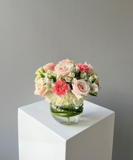 pink and white floral arrangement in bubble bowl