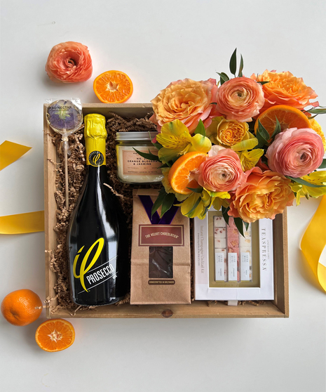 orange floral arrangement with wine and gift set