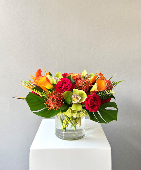 vivid tropical arrangement with roses, orchids, calla lilies, orchids, and more