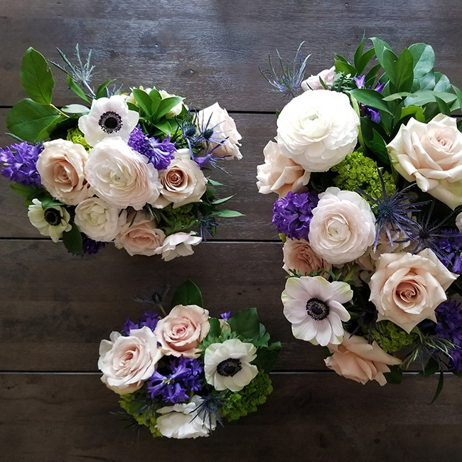 Thematically similar floral arrangements in three different sizes
